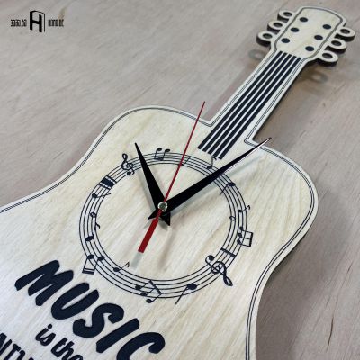 Music is the universal language of mankind (guitar shape, light wood)